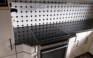 Schrägschnitte beim Kochfeld in der Nero Assoluto India Granit Arbeitsplatte eingearbeitet